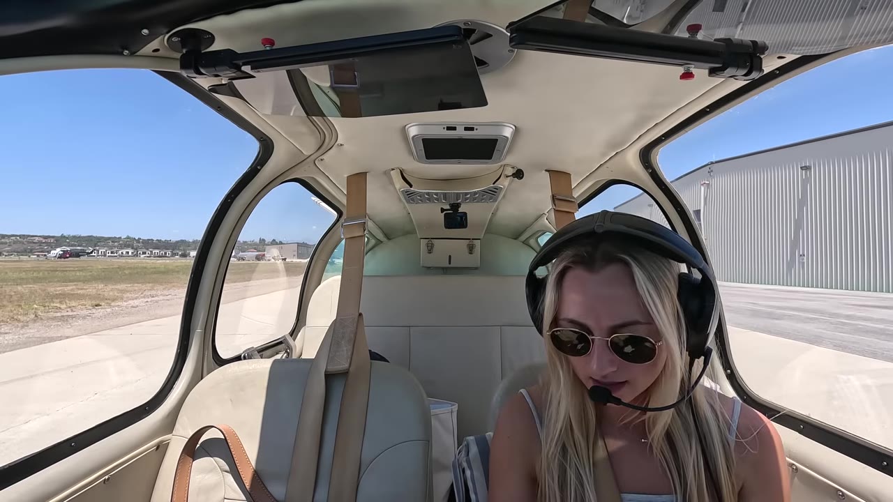 Headset on, sunglasses down — copying the ATIS and setting up before calling ground, with the flight plan already loaded in Garmin Pilot.