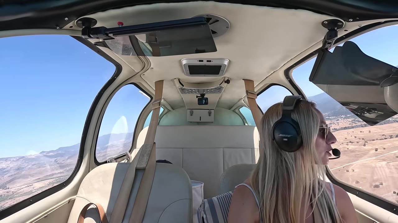 On the descent toward the field with gear down, running the pre-landing flow leg by leg — gas, undercarriage, mixture, prop, seat belts.